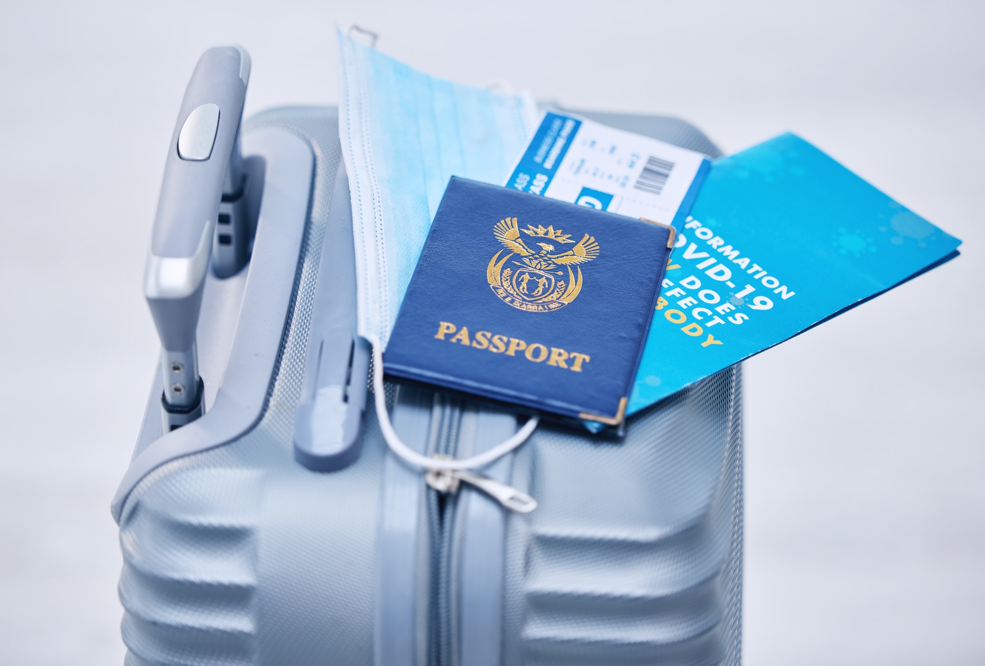 Covid, passport and suitcase for travel compliance, policy and documents in global, airport or visa